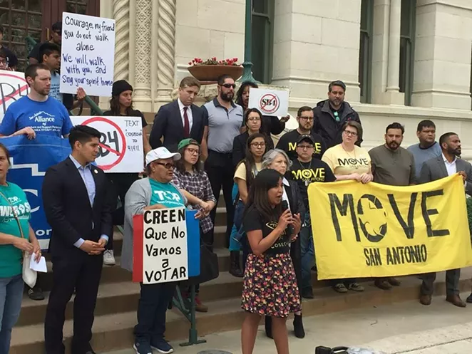 Catalina Adorno of the immigrant-rights group Cosecha addresses the crowd in front of City Hall. - SANFORD NOWLIN