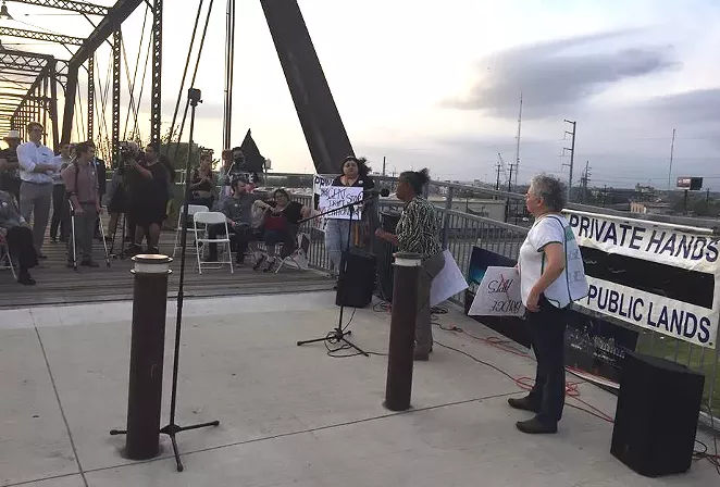 Neighborhood activist Nettie Hinton addresses the crowd at Hays Street Bridge on Monday. - SANFORD NOWLIN