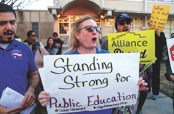Shannon Elledge, an SAISD teacher and a member of the San Antonio Alliance of Teachers Support and Personnel, protests ahead of a board vote to move forward with a partnership between Stewart Elementary School and Democracy Prep Public Schools, Monday, Jan. 22, 2018. - ALMA HERNANDEZ FOR FOLO MEDIA