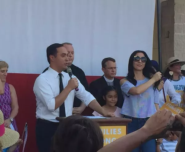 Joaquin Castro speaks at the West Side rally, surrounded by his family and local faith leaders. - SANFORD NOWLIN