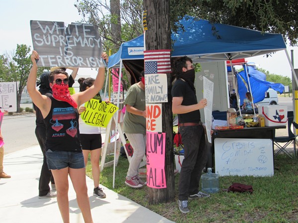 Protestors at San Antonio's small Occupy ICE encampment show off their signs. - SANFORD NOWLIN