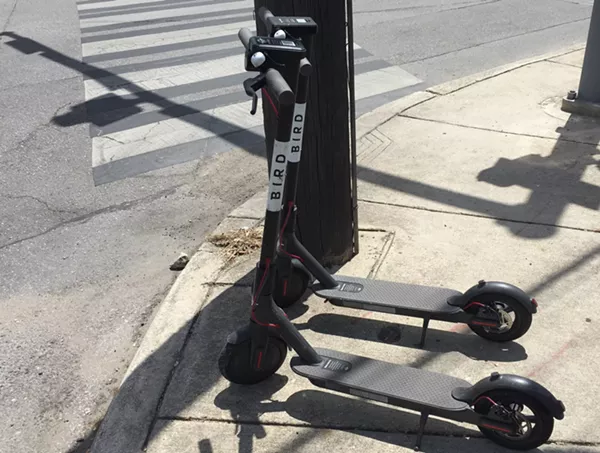 A pair of dockless scooters sit on a sidewalk along North St. Mary's Street. - SANFORD NOWLIN