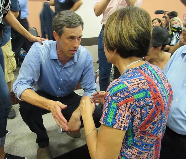 O’Rourke speaks to an audience member from the stage after a Corpus Christi town hall that drew more than 1,000 people. - SANFORD NOWLIN