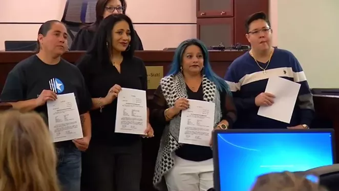 The women known as the San Antonio Four show off the papers expunging their criminal histories. - VIA @NEWS4SA
