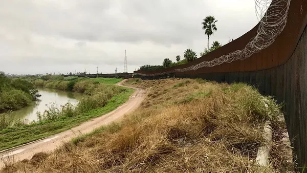 This stretch of South Texas border wall was constructed during the George W. Bush administration, but the coils of barbed wire went up during Trump’s. - REBECCA CENTENO