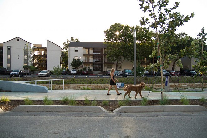 Some residents of the Soap Factory apartments, shown here with San Pedro Creek Culture Park in the foreground, have received relocation aid from the city. - HERON FILE PHOTO