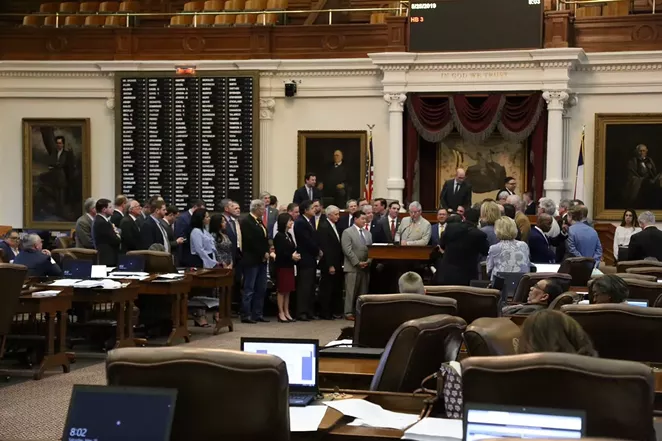 Texas lawmakers gather on the floor after passing an overhaul of the state's public chool finance system. - TWITTER / @REPDENNISBONNEN
