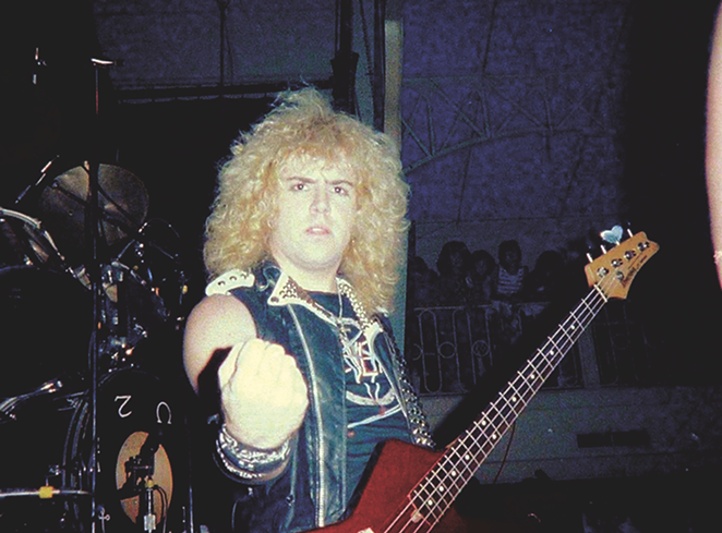 S.A. Slayer bassist and panelist Donnie Van Stavern pumps his fist in an early-'80s photo. - COURTESY