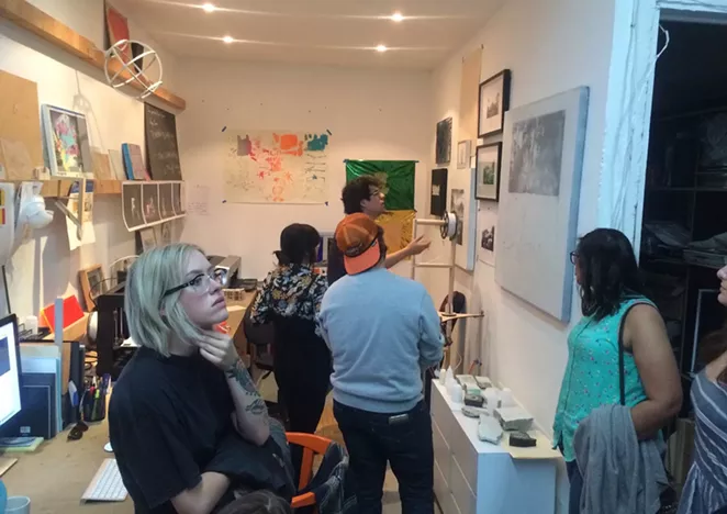 Mexico City artist Miguel Ángel “Wimpy” Salazar (in back) explains his work to a group of Texas State University students attending a study abroad program facilitated by AtrevesArte. - BRYAN RINDFUSS
