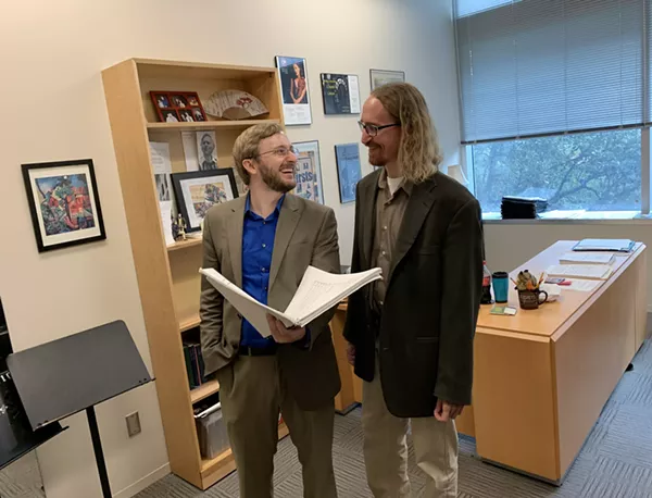 Joseph Kneer (left) and Brian Bondari share a laugh while reviewing the score of Symphony No. 2 - COURTESY OF TRINITY UNIVERSITY MUSIC DEPARTMENT