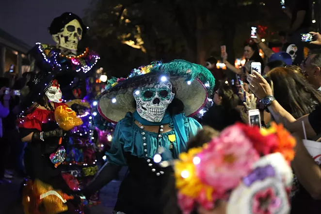 MPeople view a procession at Muertos Fest in La Villita. This year, the event is moving to Hemisfair. - BEN OLIVO