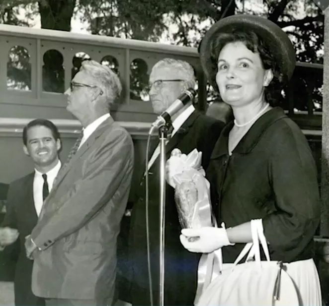 Mayor Lila Cockrell prepares to christen the San Antonio Museum of Art by breaking a bottle of beer against its façade. - TWITTER / @SAMAART