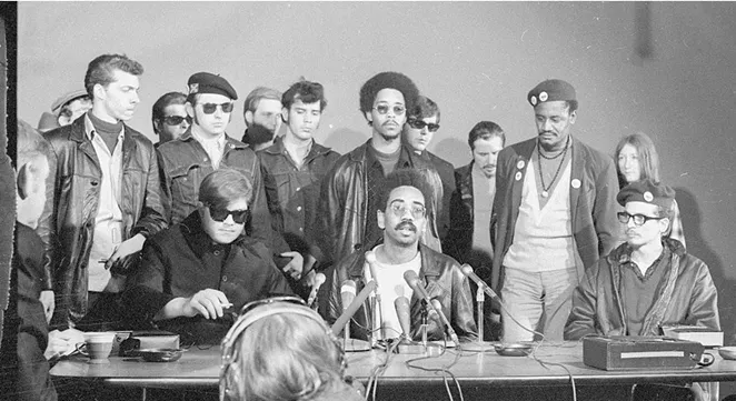 Members of the Rainbow Coalition speak at a press conference. - THE DAILY HERALD
