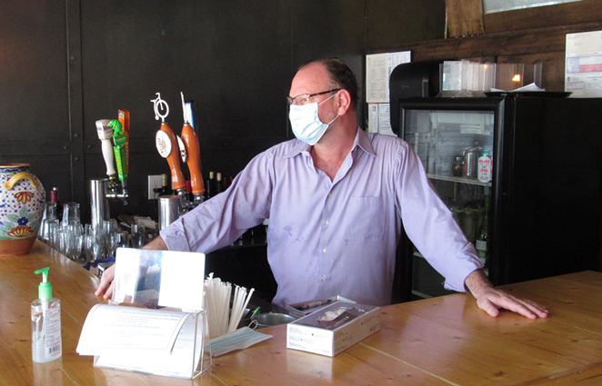 Jean Francois Poujol says it will take at least a year for his restaurant to recover from the crisis. - SANFORD NOWLIN