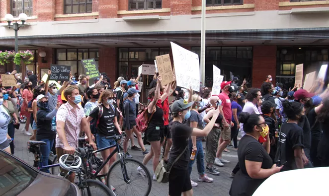Protesters walk through the streets of downtown San Antonio on Saturday evening. - SANFORD NOWLIN