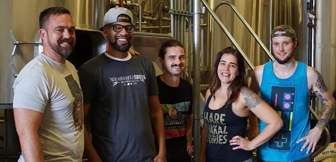 Weathered Souls founder Marcus Baskerville (second from left) visits a Miami craft brewery in 2018 — the site of another of his collaborations. - INSTAGRAM / @WEATHEREDSOULSBREWING_MARCUS