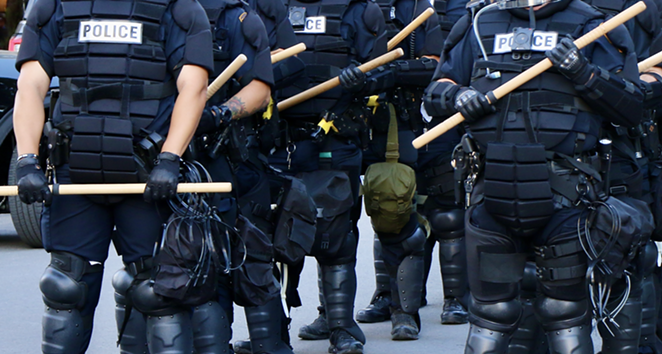 Police in riot gear stand at the ready during the George Floyd protests in San Antonio on Saturday, May 30. - JAMES DOBBINS
