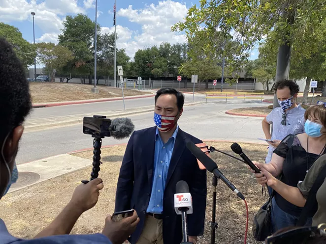 U.S. Rep. Joaquin Castro speaks to reporters outside San Antonio's main post office distribution site. - SANFORD NOWLIN