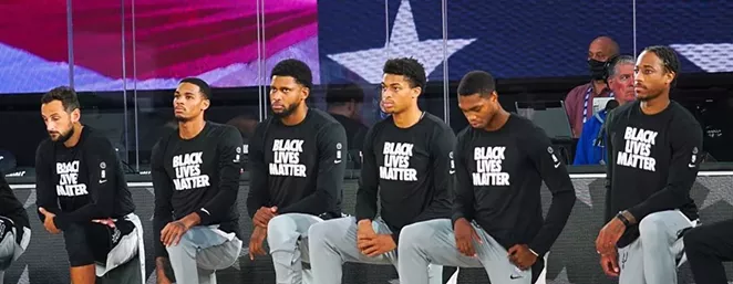 Members of the San Antonio Spurs take a knee during a recent game. - INSTAGRAM / @SPURS