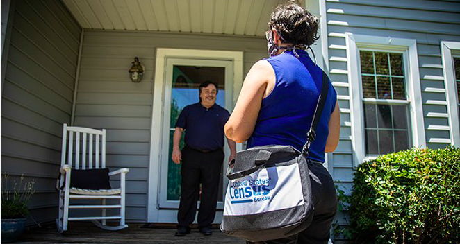 A census taker maintains social distance as she visits a home. - COURTESY PHOTO / U.S. CENSUS BUREAU