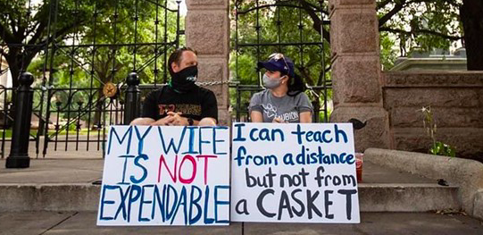 A Texas teacher and her husband attend a recent protest over the state's school reopening plan. - TWITTER / @BECKILAOSHI