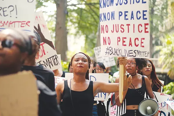 Local Black Lives Matter activists with the group SATX4 takes to downtown during an August protest. - DARCELL DESIGNS