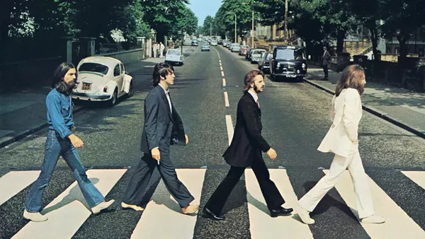 The cover of Abbey Road, said to depict a funeral procession - VIA BIOGRAPHY.COM