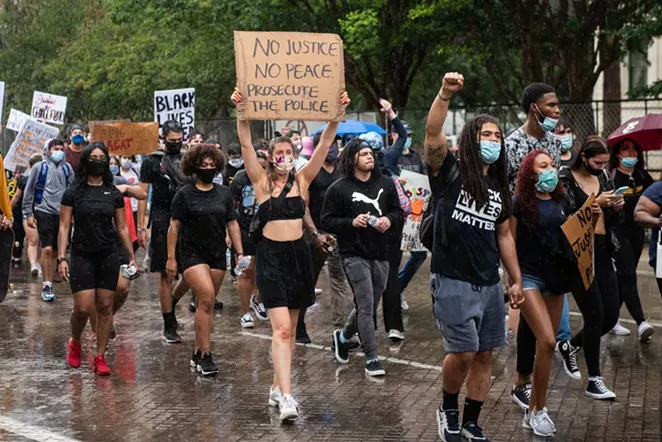 Activists demand police accountability during a protest earlier this year. - JAIME MONZON
