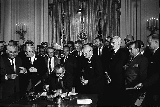 This photo shows President Lyndon B. Johnson signing the Civil Rights Act on July 2, 1964. Lone Star State Democrats will take up a resolution at the Texas Democratic Convention this week supporting the Equality Act of 2015, which would add protections for sexual identity and gender orientation to the Civil Rights Act. - CECIL STOUGHTON, WHITE HOUSE PRESS OFFICE (WHPO) | WIKIPEDIA