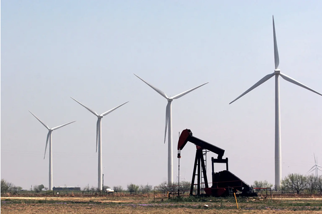 A working pump jack on the Cline Shale sits among wind turbines that cover the landscape south of Sweetwater. - MARK GRAHAM FOR THE TEXAS TRIBUNE