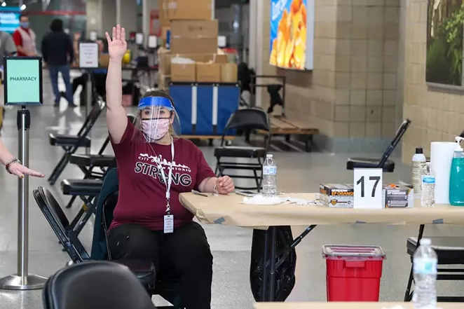 A worker at the city of San Antonio's Alamodome vaccination site calls on the next person in line to get their shot — the first step toward raging responsibly indoors. - COURTESY PHOTO / CITY OF SAN ANTONIO