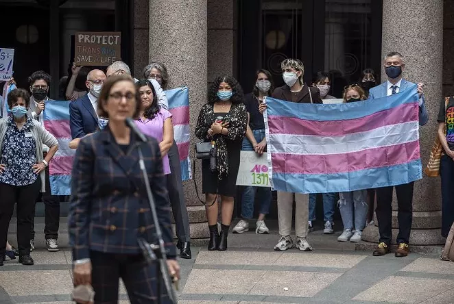 People held up a transgender flag earlier this month at an Equality Texas event at the Capitol. - SERGIO FLORES / THE TEXAS TRIBUNE