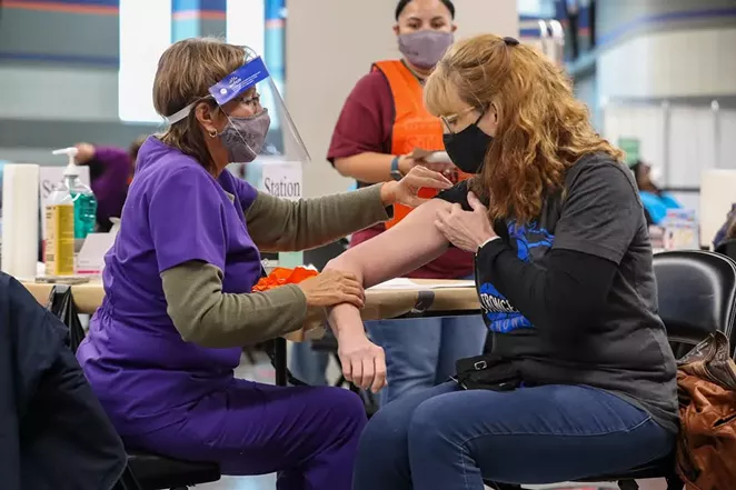 A San Antonio resident receives her shot at the Alamodome mass-vaccination site. - COURTESY PHOTO / CITY OF SAN ANTONIO