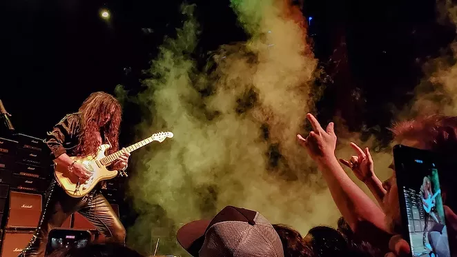 At one point, Malmsteen encouraged fans to meet him at the front of the stage. - OSCAR MORENO