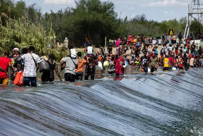 Migrants cross the Rio Grande between the United States and Mexico in Ciudad Acuña, across the border from Del Rio. - TEXAS TRIBUNE / JORDAN VONDERHAAR