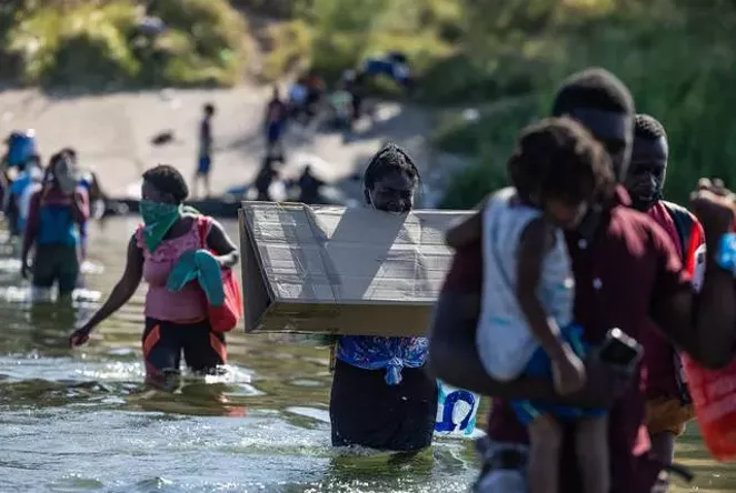 Migrants have waded across the Rio Grande to buy water, food and other supplies in Ciudad Acuña as they wait for their turn to request asylum on the U.S. side. - TEXAS TRIBUNE / JORDAN VONDERHAAR