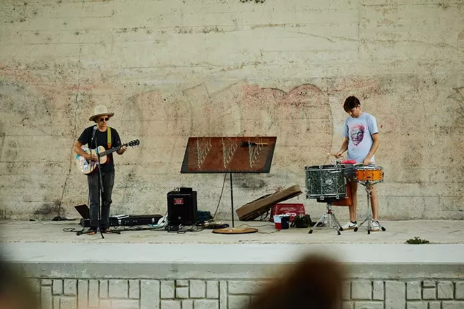 Bill Baird (left) and Jordan Johns perform August 28 under the Roosevelt Avenue Bridge. - SA HERON / TYLER SMITH