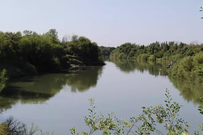 Los Ebanos' hand-pulled ferry takes passengers across the Rio Grande. - GUS BOVA