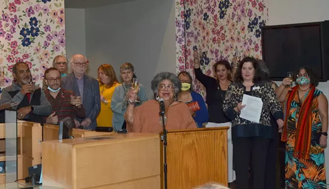 UTSA Professor Emerita Ellen Riojas Clark raises a glass to the late Gregg Barrios. - SAN ANTONIO CURRENT STAFF