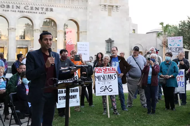 Musical Bridges Around the World’s Suhail Arastu speaks in support of the striking Symphony musicians at a rally in front of the Tobin Center Friday, Oct. 29. - KATELYN EARHART