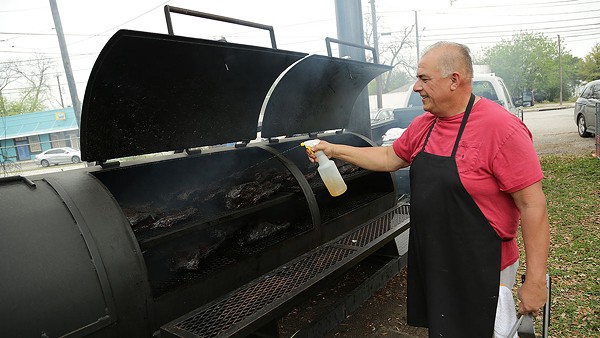 Andrew Garcia, co-owner of Garcia’s Mexican Food, 842 Fredericksburg Road, tends to briskets on the smoker behind the restaurant. - BENJAMIN OLIVO / THE TACOIST
