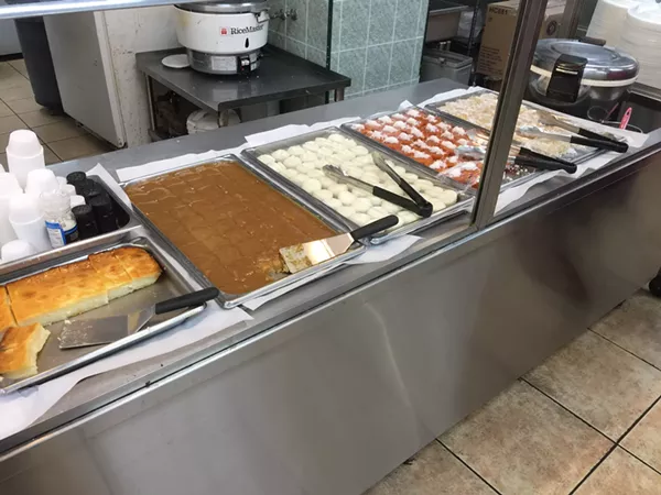 Cassava cake (far left), bibingka, puto and other Filipino desserts. - HANNAH LYNN