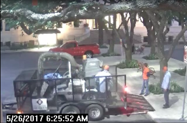 City landscapers watch as a security guard wakes Councilman Alan Warrick - CITY OF SAN ANTONIO VIA SAN ANTONIO EXPRESS-NEWS
