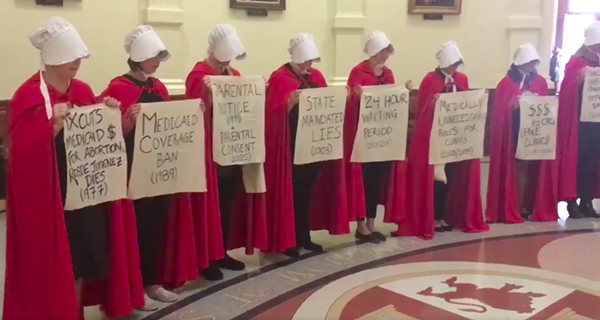 Women dressed like characters from The Handmaid's Tale protesting anti-abortion bills at the Texas state capitol. - SCREENSHOT, ALEXA GARCIA-DITTA VIA TWITTER.COM