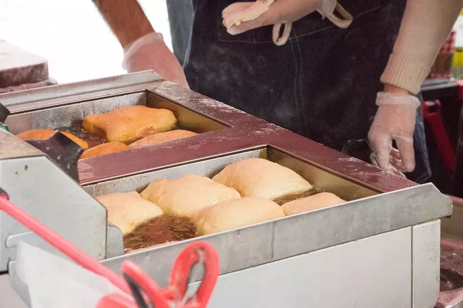 The dough is added to a hot oil fryer and cooked for two to three minutes, until golden-brown. - LEA THOMPSON
