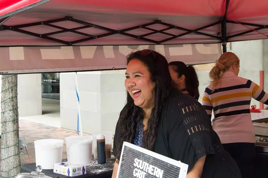 Elsa Treviño warmly greets and explains the Southern Grit menu to customers, and ensures that every order of beignets is delivered hot and fresh. - LEA THOMPSON