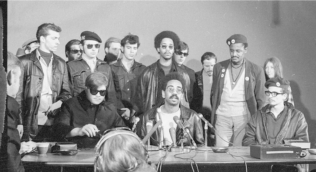 Members of the Rainbow Coalition speak at a press conference. - THE DAILY HERALD