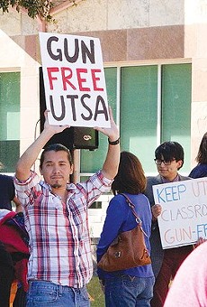 A demonstrator at UTSA protests the campus carry law.