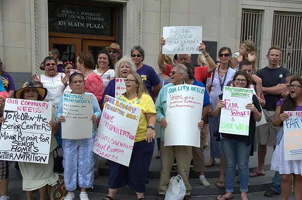 SEIU members rally at City Hall in June to increase wages for city employees. - MICHAEL MARKS