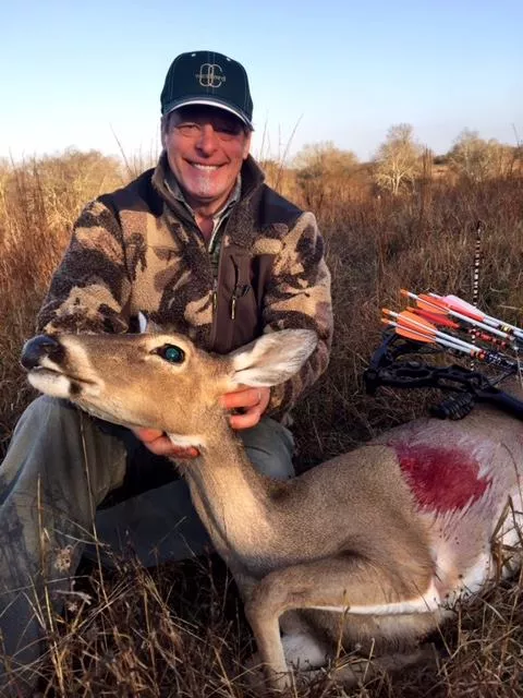 Uncle Ted, a real patriot, and blood-splattered deer carcass. Notice that despite the animal's deceased state, it still has a gleam in its eye when having its picture taken. - VIA FACEBOOK